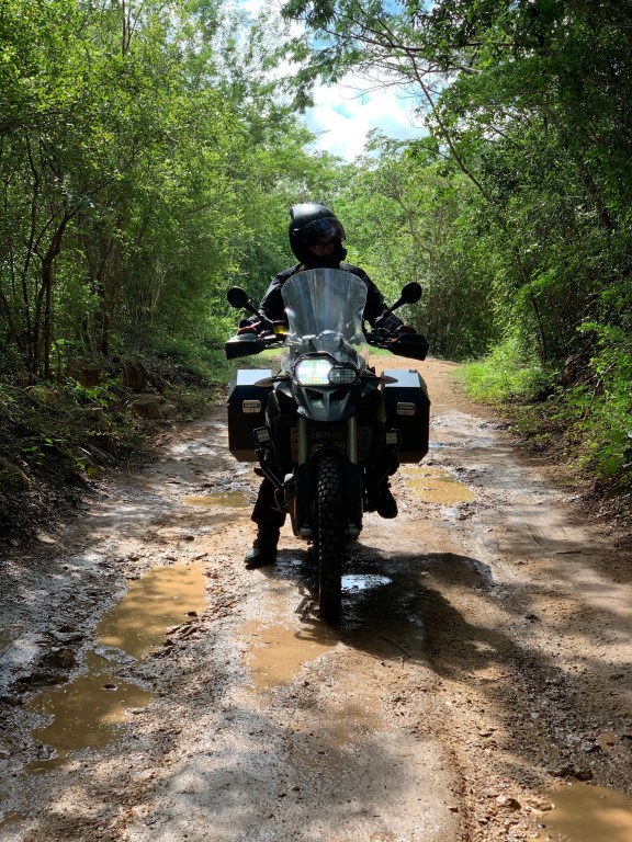 Woman on adventure bike, riding on mud in Yucatan